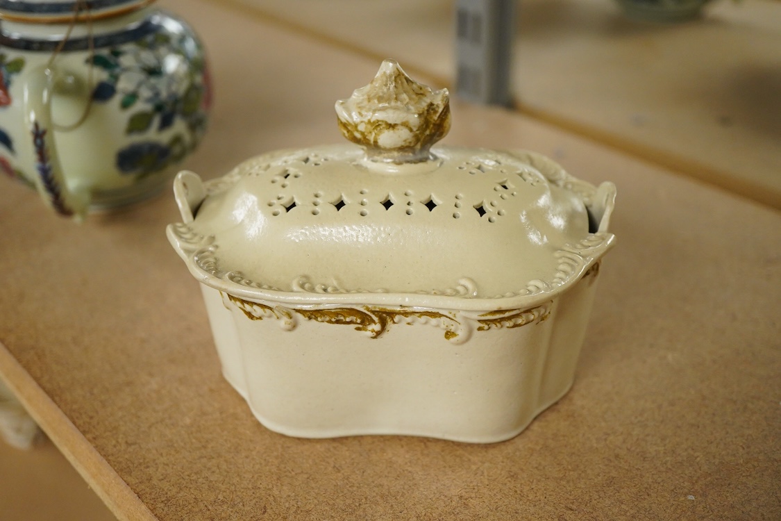 A rare Staffordshire saltglaze stoneware teapot, mid 18th century, an early 19th Wedgwood stoneware teapot and a stoneware butter tub and cover - 13cm wide (3)